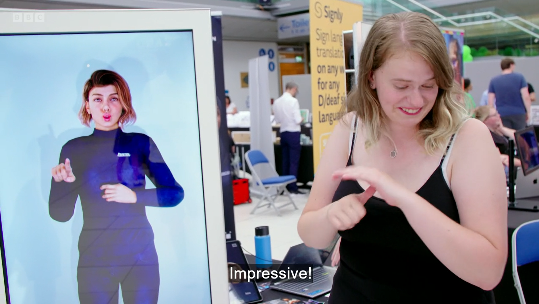 Lara Scott with Cassie at the Norfolk Deaf Festival, signing "Impressive!"